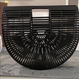 Black Ark clutch, top handles and a cut detail.